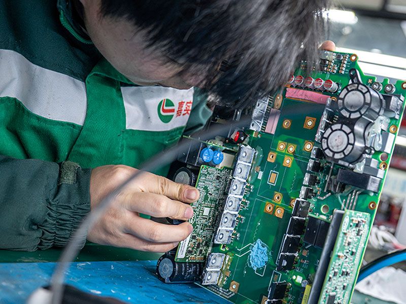 Factory workers assembling electric vehicles in a large factory in China