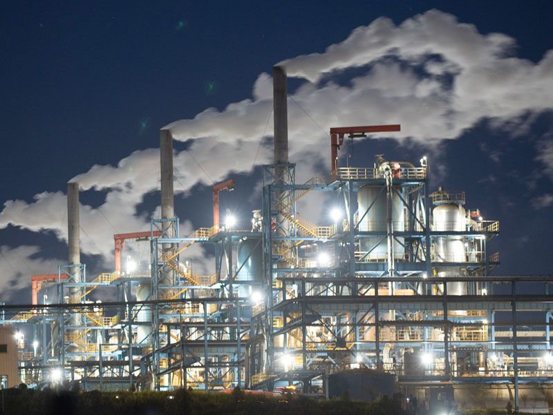 Factory workers assembling electric vehicles in a large factory in Indonesia