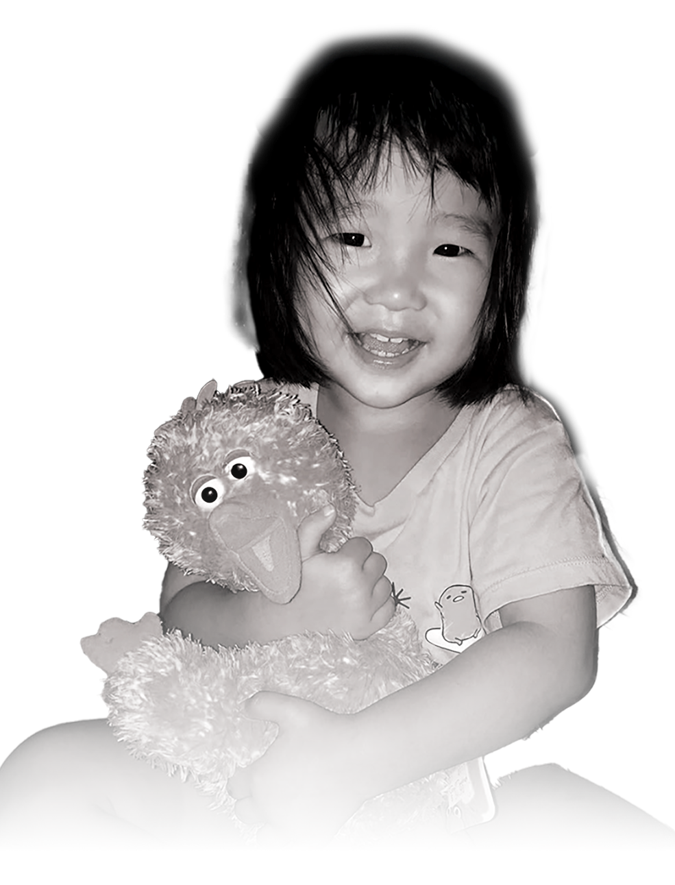 A smiling Megan Khung holding a stuffed Big Bird toy close to her chest.